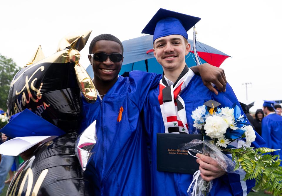 Valentine Mireku and Abdul Makhzoum hold graduation gifts.