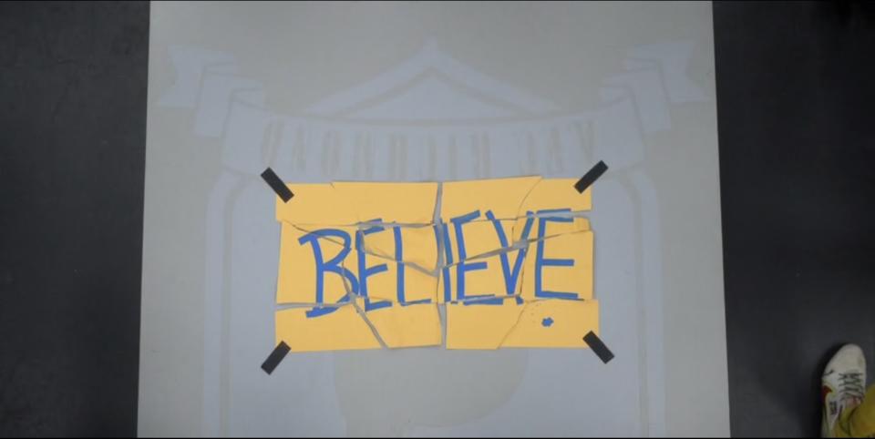 A tattered sign that says "Believe"