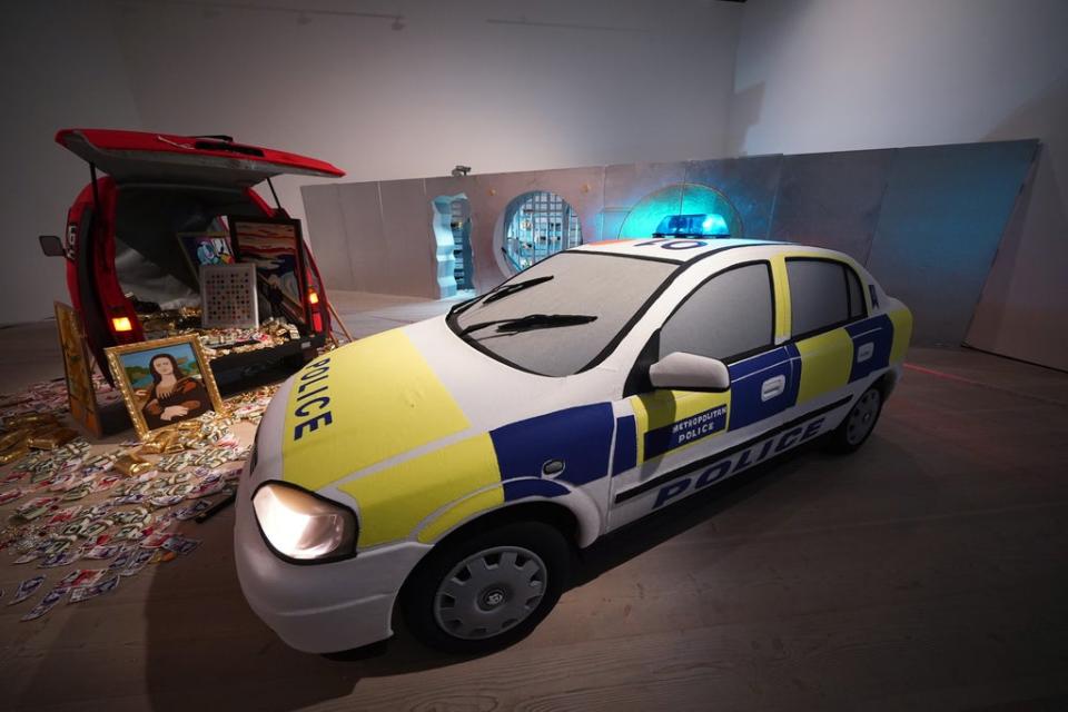 A Metropolitan Police squad car with blue lights flashing has arrived on the scene to intercept the perpetrators of a billion-dollar robbery (Yui Mok/PA) (PA Wire)