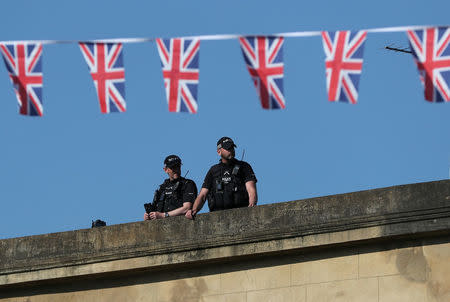 Armed police officers stand guard on a roof, ahead of the wedding of Prince Harry and Meghan Markle, in Windsor, Britain, May 19, 2018. REUTERS/Marko Djurica