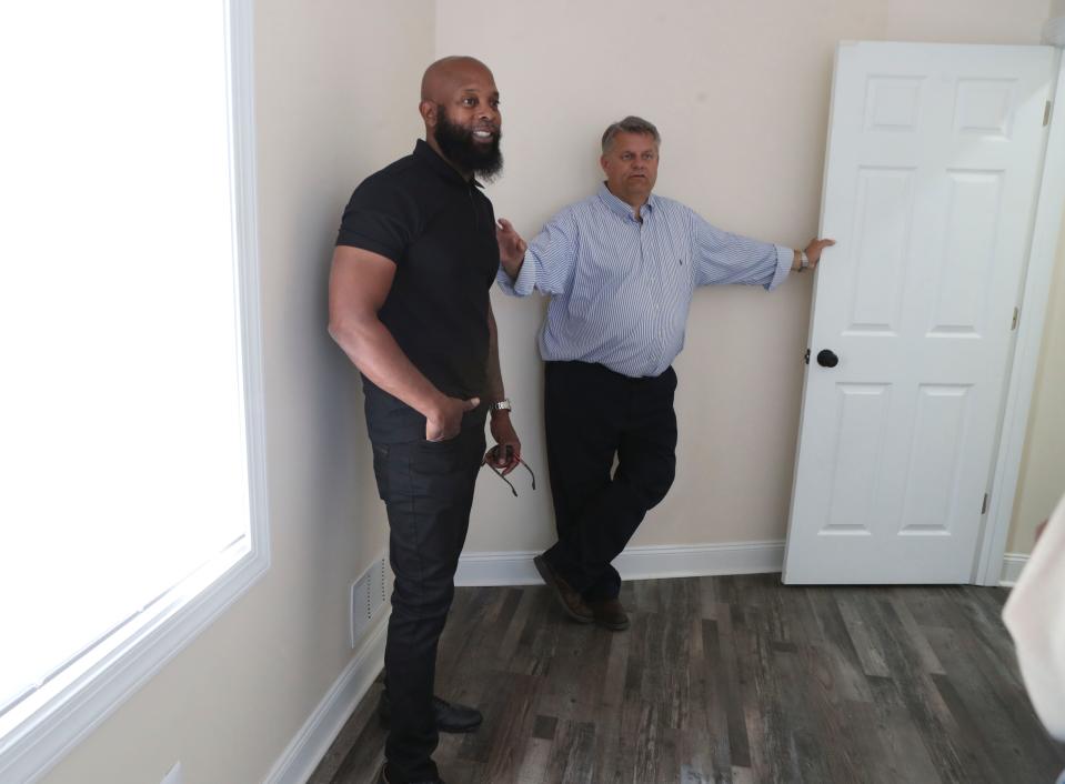 Contractor Richard Dyton (left) and Woodlawn Trustees CEO Rich Przywara show off a newly rehabbed residence in Wilmington's Eastside neighborhood that was made habitable again after years of neglect, Wednesday, Oct. 4, 2023.