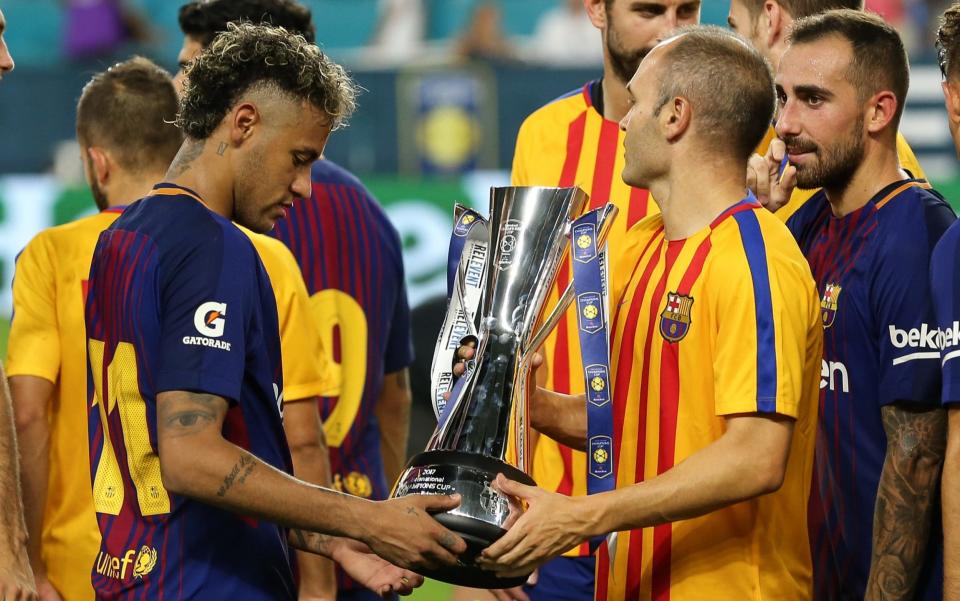 Neymar of FC Barcelona and Andres Iniesta of FC Barcelona lift the International Champions Cup trophy during the International Champions Cup 2017 match between Real Madrid and FC Barcelona at Hard Rock Stadium on July 29, 2017 in Miami Gardens, Florida - Credit: Getty