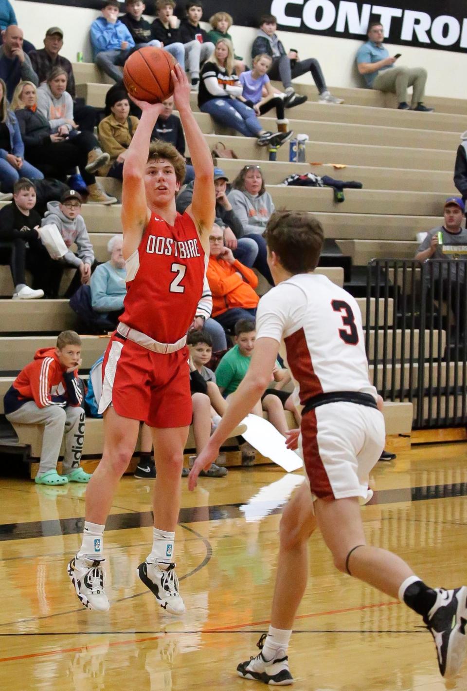 Oostburg’s Cade Dirkse (2) launches an outside shot by Cedar Grove-Belgium’s Ethan Aponte (3), Thursday, February 2, 2023, in Cedar Grove, Wis.