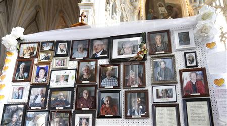 Pictures of victims of the Residence du Havre fire are displayed during a memorial ceremony at the Decollation-de-Saint-Jean-Baptiste church in L'Isle Verte, Quebec, February 1, 2014. REUTERS/Mathieu Belanger