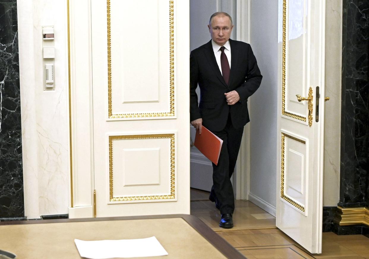 Russian President Vladimir Putin enters a hall to chair a Security Council meeting in Moscow, Russia, Friday, Feb. 25, 2022. Putin ordered Russian nuclear deterrent forces put on high alert Sunday, Feb. 27, amid tensions with the West over his invasion of Ukraine.