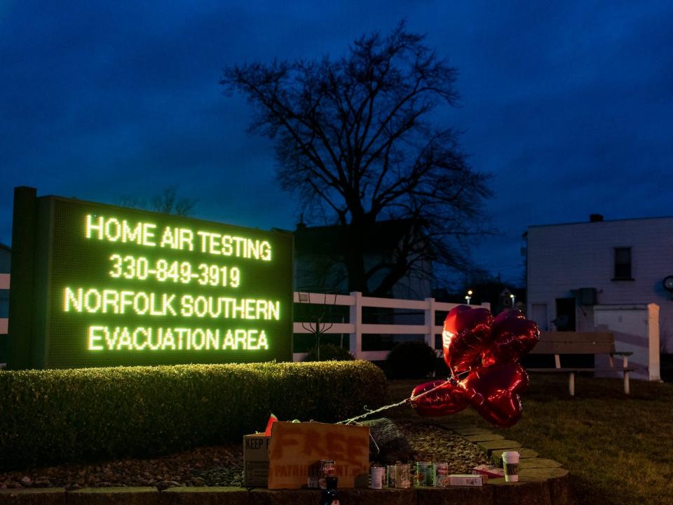 Balloons are placed next to a sign displaying information for residents to receive air-quality tests from Norfolk Southern Railway on February 16, 2023 in East Palestine, Ohio. On February 3rd, a Norfolk Southern Railways train carrying toxic chemicals derailed causing an environmental disaster.