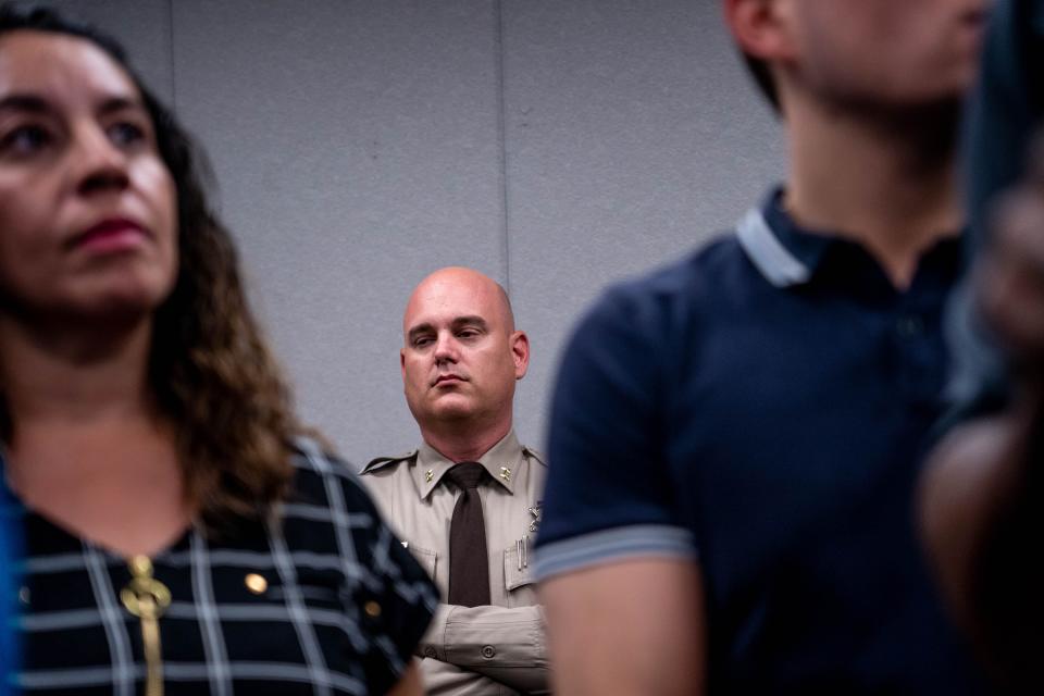 A Maricopa County deputy watches a press conference addressing upcoming election security, at the Maricopa County Sheriff's Office headquarters in Phoenix on July 20, 2022.