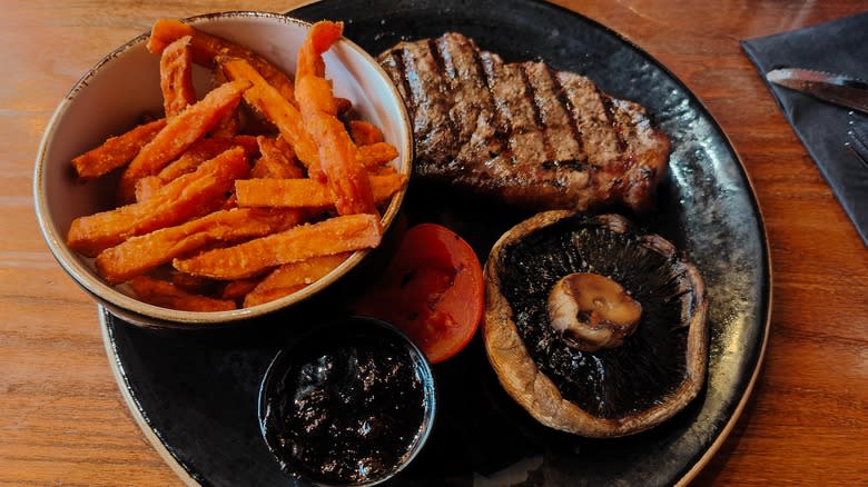 Plate with steak, sweet potato fries, mushroom