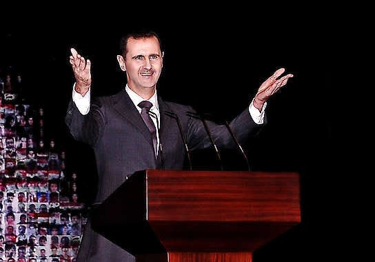 Syrian President Bashar Assad gestures as speaks Sunday at the Opera House in central Damascus, Syria. Assad outlined a new peace initiative that includes a national reconciliation conference and a new government and constitution but demanded regional and Western countries stop funding and arming rebels first. SANA | Associated Press