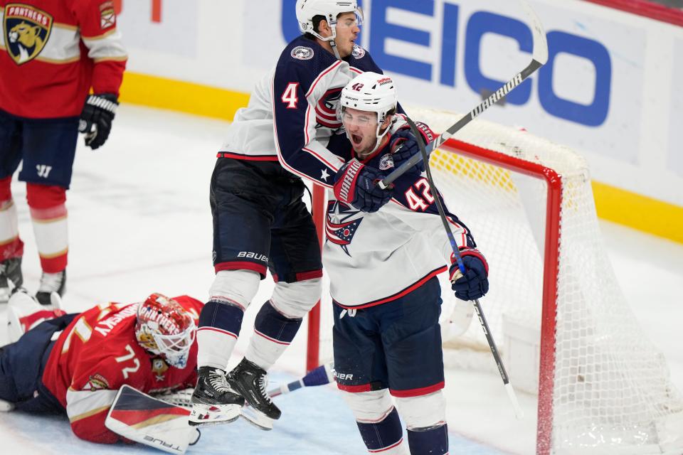 Columbus Blue Jackets center Cole Sillinger (4) leaps onto center Alexandre Texier (42) after Texier scored during the third period of an NHL hockey game against the Florida Panthers, Monday, Nov. 6, 2023, in Sunrise, Fla. (AP Photo/Wilfredo Lee)