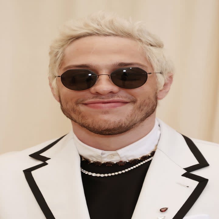 Pete Davidson smiles as he rocks sunglasses on the red carpet