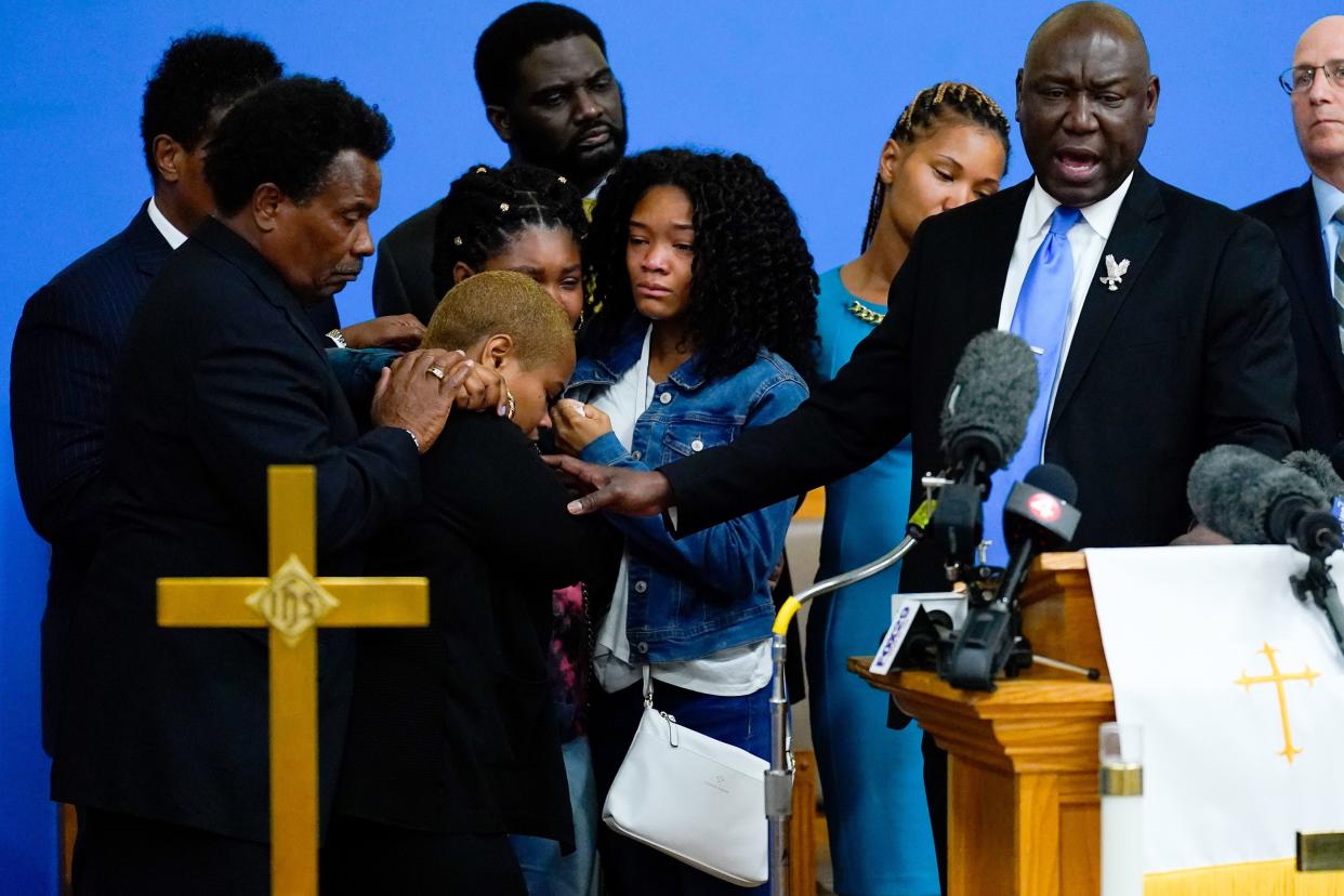 Attorney Benjamin Crump, right, accompanied by the family of Ruth Whitfield, a victim of shooting at a supermarket, speaks with members of the media during a news conference in Buffalo, N.Y., Monday, May 16, 2022.