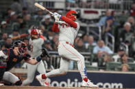 Philadelphia Phillies designated hitter Bryce Harper (3) hits a solo homer against the Atlanta Braves during the sixth inning of Game 1 of a baseball NL Division Series, Saturday, Oct. 7, 2023, in Atlanta. (AP Photo/Brynn Anderson)