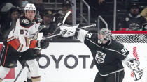 Los Angeles Kings goaltender Jonathan Quick, right, deflects a shot as Anaheim Ducks center Rickard Rakell stands by during the second period of an NHL hockey game Tuesday, Nov. 30, 2021, in Los Angeles. (AP Photo/Mark J. Terrill)