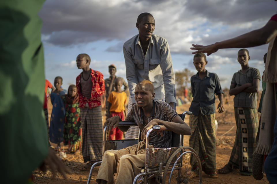 Displaced people who have arrived at a camp wait for plot allocation on the outskirts of Dollow, Somalia, on Monday, Sept. 19, 2022. Somalia is in the midst of the worst drought anyone there can remember. A rare famine declaration could be made within weeks. Climate change and fallout from the war in Ukraine are in part to blame. (AP Photo/Jerome Delay)