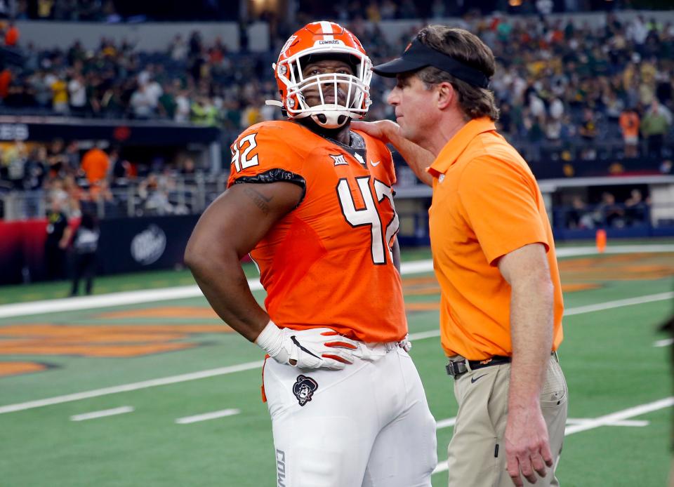 OSU coach Mike Gundy consoles Jayden Jernigan (42) following the Big 12 championship game on Dec. 4.