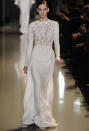 <b>Elie Saab SS13 </b><br><br>We also saw more streamlined fabrics in the key colours, including neutral white, made more intriguing by the fine cut out details on the bodice.<br><br>©Rex