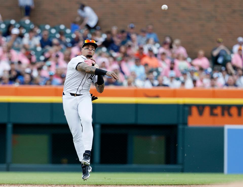 Tigers shortstop Javier Baez throws to first base on a grounder by Brewers right fielder Sal Frelick of but can't make the out during the second inning on Saturday, June 8, 2024, at Comerica Park.