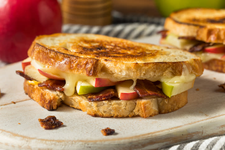 Close up photo of a grilled cheese sandwich with apples and bacon. 