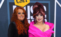 FILE - Wynonna Judd, left, and Naomi Judd arrive at the CMT Music Awards on Monday, April 11, 2022, at the Municipal Auditorium in Nashville, Tenn. Naomi Judd, the Kentucky-born matriarch of the Grammy-winning duo The Judds and mother of Wynonna and Ashley Judd, has died, her family announced Saturday, April 30, 2022. She was 76. (AP Photo/John Amis, File)