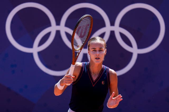 Anna Karolina Schmiedlova plays in front of the Olympic rings