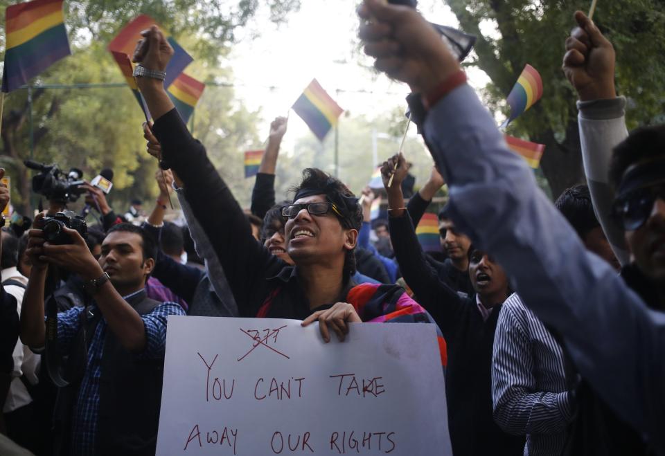 Gay rights activists wave flags and shout slogans as they attend a protest against a verdict by the Supreme Court in New Delhi December 11, 2013. India's Supreme Court on Wednesday reinstated a ban on gay sex in the world's largest democracy, following a four-year period of decriminalisation that had helped bring homosexuality into the open in the socially conservative country. In 2009 the Delhi High Court ruled unconstitutional a section of the penal code dating back to 1860 that prohibits "carnal intercourse against the order of nature with any man, woman or animal" and lifted the ban for consenting adults. The Supreme Court threw out that decision, saying only parliament could change Section 377 of the penal code, widely interpreted to refer to homosexual sex. Violation of the law can be punished with up to 10 years in jail. (REUTERS/Anindito Mukherjee)