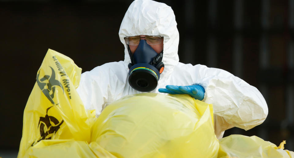 Clinical waste removal personnel at St Basil’s Homes for the Aged in Fawkner on Friday. Source: AAP