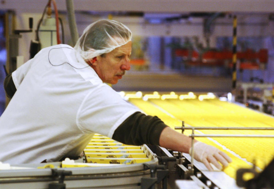 FILE - In this April 2, 2003 file photo, a worker at the Just Born factory in Bethlehem, Pa., keeps an eye on the Marshmallow Peeps that pass by on the conveyor belt. The Bethlehem, Pa.,-based Just Born confections company said its production facilities there and in Philadelphia closed Wednesday, March 25, 2020, through April 7. The company says it had already produced and shipped the Easter supply of its signature marshmallow confection to outlets. (AP Photo/Rick Smith, file)