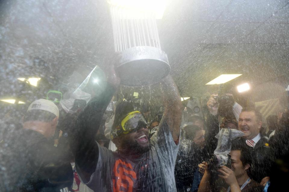 Oct 29, 2014 file photo; Kansas City, MO, USA; San Francisco Giants third baseman Pablo Sandoval celebrates with the Commissioners Trophy in the clubhouse after game seven of the 2014 World Series against the Kansas City Royals at Kauffman Stadium. Mandatory Credit: Christopher Hanewinckel-USA TODAY Sports/Files (TPX IMAGES OF THE DAY SPORT)