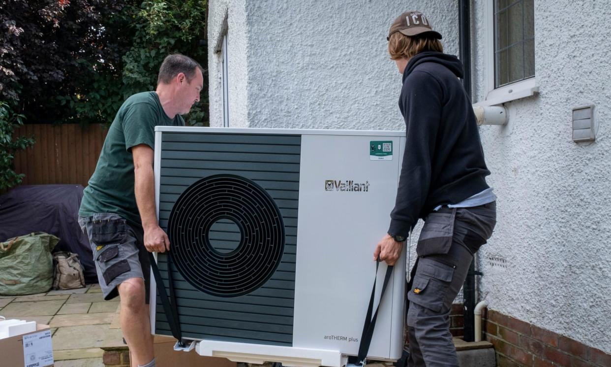 <span>Workmen installing a heat pump in Folkestone. The technology is said to be three times more efficient than gas boilers.</span><span>Photograph: Andrew Aitchison/In Pictures/Getty Images</span>