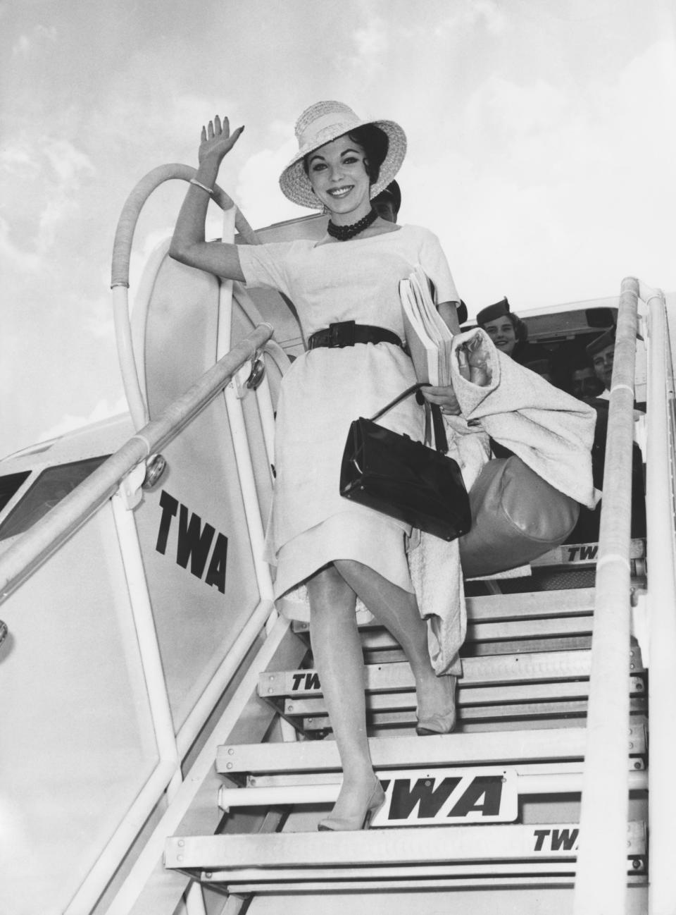 British actress Joan Collins arrives at Ciampino Airport in Rome, Italy, to star in the film 'Esther and the King', 13th June 1960.