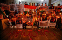 People pay tribute to Central Reserve Police Force (CRPF) personnel who were killed in an explosion in south Kashmir, inside a temple in Ahmedabad, India, February 14, 2019. REUTERS/Amit Dave