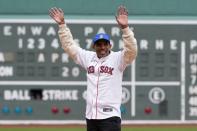 Meb Keflezighi waves to the crowd before throwing out the ceremonial first pitch before a baseball game between the Boston Red Sox and the Los Angeles Angels, Sunday, April 14, 2024, in Boston. (AP Photo/Michael Dwyer)