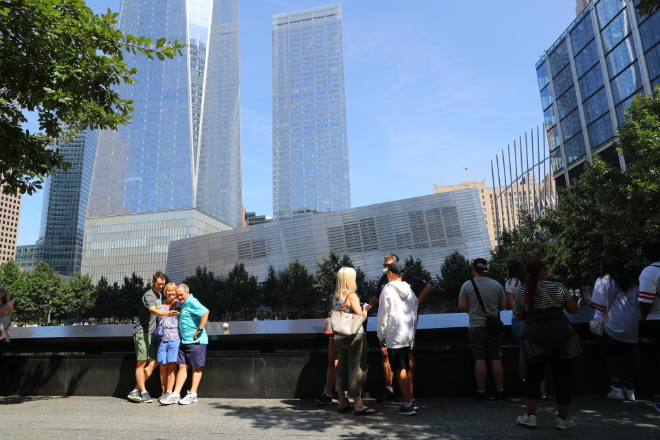 <p>Visitors gather to pay tribute to the victims of the 9/11 attacks near one of two reflecting pools at the National September 11 Memorial & Museum on Sept. 4, 2017. (Photo: Gordon Donovan/Yahoo News) </p>