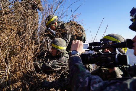 Soldiers from North and South Korea verify the removal of guard posts on each side of the Demilitarized Zone, December 12, 2018. South Korean Defence Ministry/Handout via REUTERS