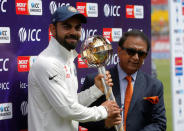 Cricket - India v Australia - Fourth Test cricket match - Himachal Pradesh Cricket Association Stadium, Dharamsala - 28/03/17 - India's Virat Kohli receives the ICC Test Mace from former Indian cricket player Sunil Gavaskar (R) after India won the test series against Australia. REUTERS/Adnan Abidi