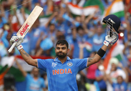 Batsman Virat Kohli acknowledges the crowd upon scoring a century during their Cricket World Cup match against Pakistan in Adelaide, February 15, 2015. REUTERS/David Gray