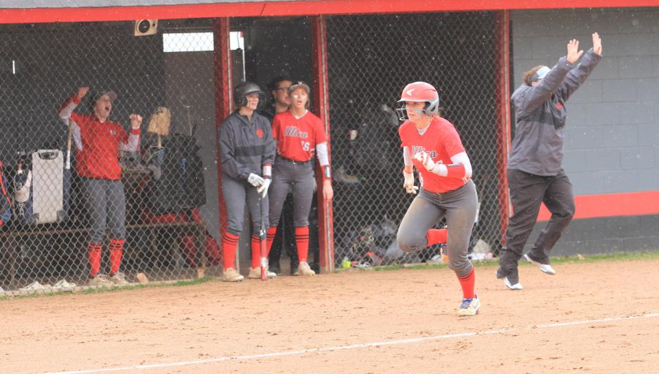 Utica junior Lauren Schmitt heads home to score on a hit by sophomore Cheyenne Smith against East Knox during a 14-11 loss to the visiting Bulldogs on Wednesday, March 29, 2023.