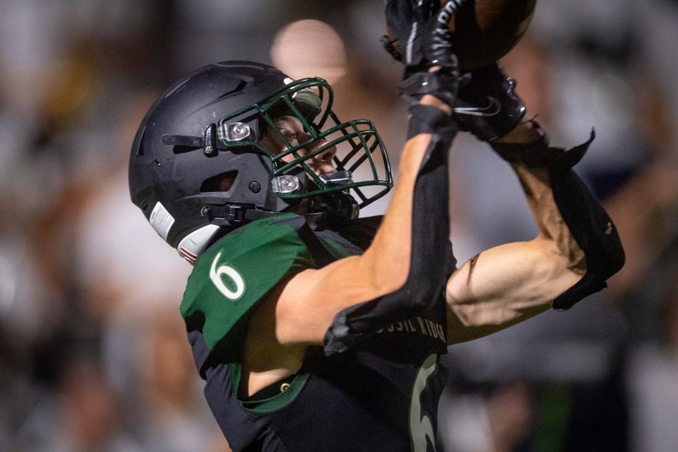 Fossil Ridge's Trek Keyworth scores the winning touchdown against Loveland during their game at PSD Stadium in Timnath on Thursday, Aug. 25, 2022.