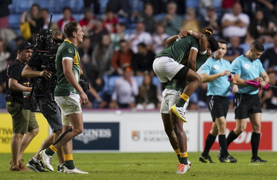 South African players celebrate after beating Fiji in the Men's Rugby Sevens gold medal match, at Coventry Stadium, England, on day three of the Commonwealth Games, Sunday July 31, 2022. (Jacob King/PA via AP)