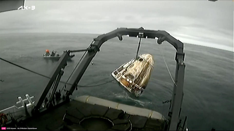 The Crew Dragon is hauled aboard the SpaceX recovery ship Shannon about a half hour after splashdown. / Credit: SpaceX web stream