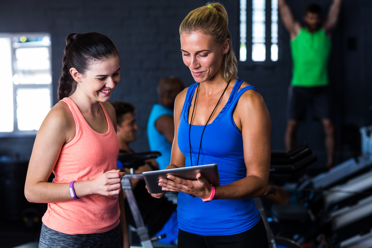 Woman speaking with a fitness trainer