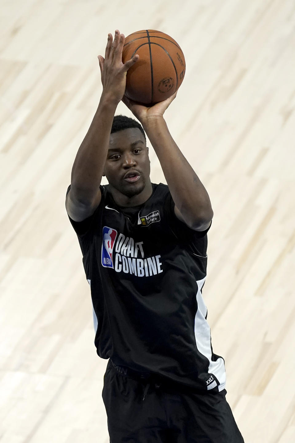 FILE - Ariel Hukporti from Germany shoots as he participates in the NBA Draft Combine at the Wintrust Arena on June 22, 2021, in Chicago. Ariel Hukporti is an athletic 7-foot center for Melbourne United in Australia. He's been on NBA teams' radars since winning MVP of the 2020 Basketball Without Borders camp. The 250-pound big withdrew from the 2021 NBA draft in hopes of improving his stock with another year of development. The 19-year-old is part of the National Basketball League's "Next Stars” program whose alumni include first-round picks LaMelo Ball, R.J. Hampton and Josh Giddey.(AP Photo/Charles Rex Arbogast, File)