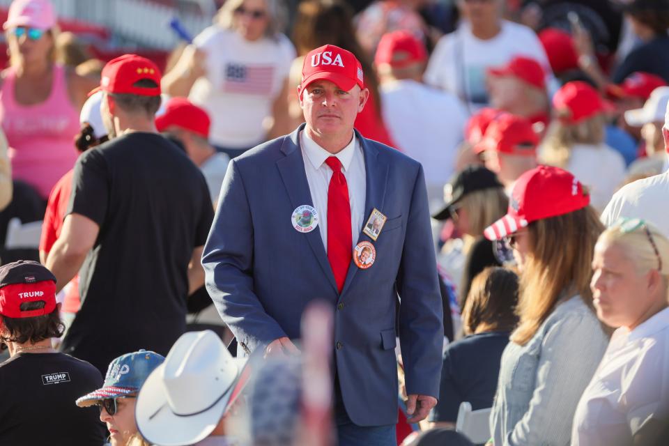 A Trump supporter looks on before former President Donald Trump is scheduled to speak at Ted Hendricks Stadium at Henry Milander Park in Hialeah, Florida, Wednesday, November 8, 2023.