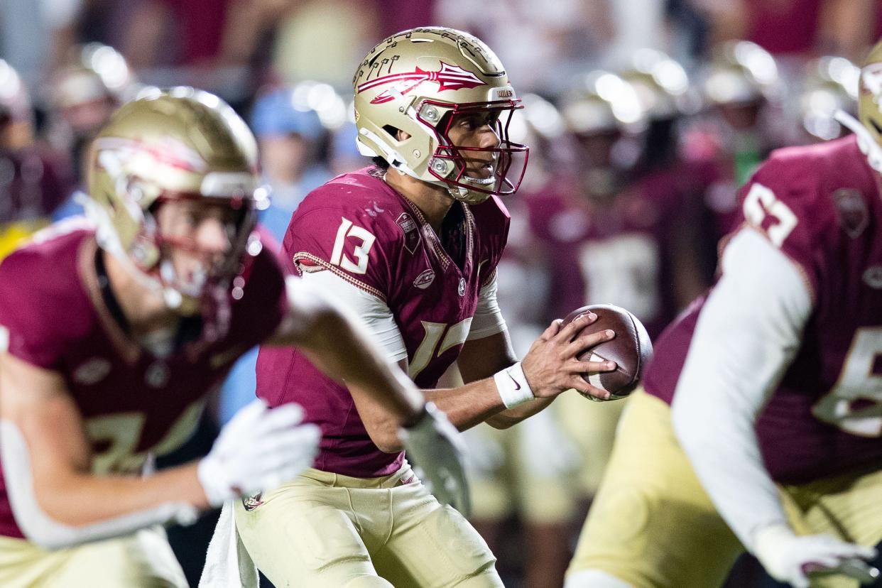 Florida State Seminoles quarterback Jordan Travis (13) looks to pass to his teammate. The Florida State Seminoles defeated the Miami Hurricanes 27-20 on Saturday, Nov. 11, 2023.