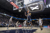 Villanova's Justin Moore (5) shoots over Xavier's Nate Johnson (10) during the second half of an NCAA college basketball game, Wednesday, Jan. 12, 2022, in Cincinnati. (AP Photo/Jeff Dean)