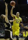 Michigan forward Jordan Morgan (52) and Wofford forward C.J. Neumann (31) battle for a rebound during the first half of a second round NCAA college basketball tournament game Thursday, March 20, 2014, in Milwaukee. (AP Photo/Morry Gash)