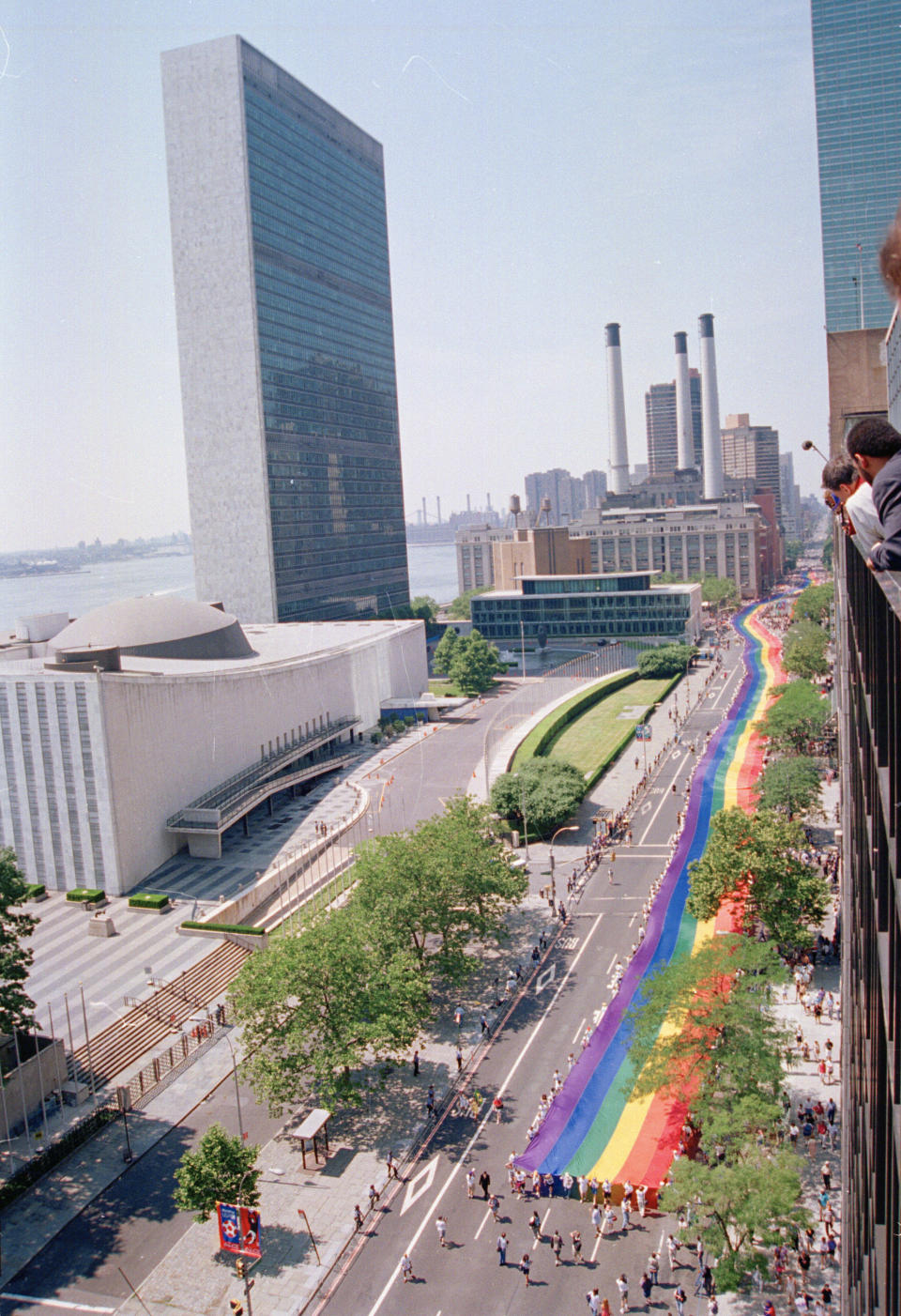 FILE- In this June 26, 1994 file photo, marchers carrying a mile-long rainbow banner up First Avenue past the United Nations in New York City during the Stonewall 25 parade, marking the 25th anniversary of the Stonewall uprising. June 2019 Pride Month marks the 50th Anniversary of the Stonewall uprising with events that commemorate that moment and its impact through the last five decades. (AP Photo/Eric Miller, File)