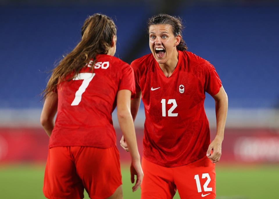 Canadian soccer player Christine Sinclair celebrates with teammate Julia Grosso