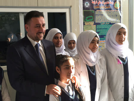 Khamis Khanjar, (L) a Sunni multimillionaire, visits displaced Sunni Iraqis at a school he funds in Iraqi Kurdistan, Iraq, February 16, 2016. REUTERS/Ned Parker